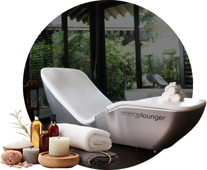 Energy Lounger spa chair with towels and wellness accessories.