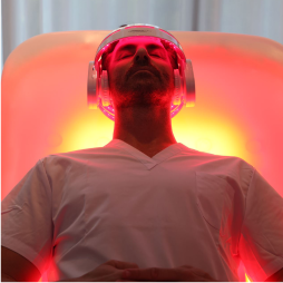 EnergyLounger red light therapy chair with a person resting inside.