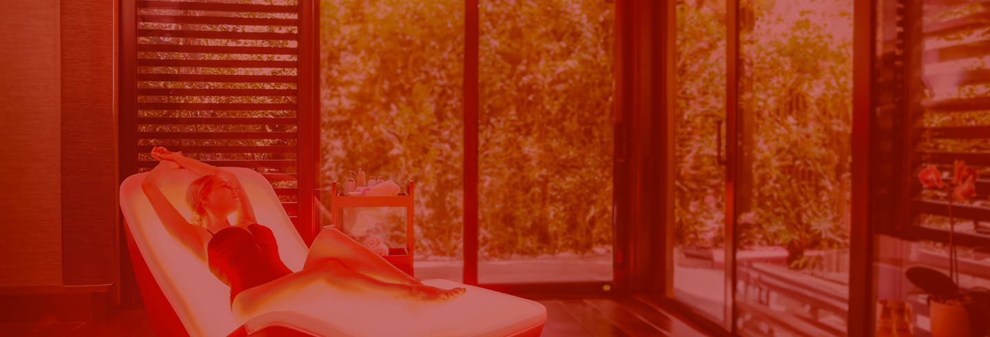 Person relaxing on an Energy Lounger with full-body light therapy.